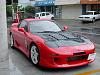 Black hood on red car-front-raining.jpg